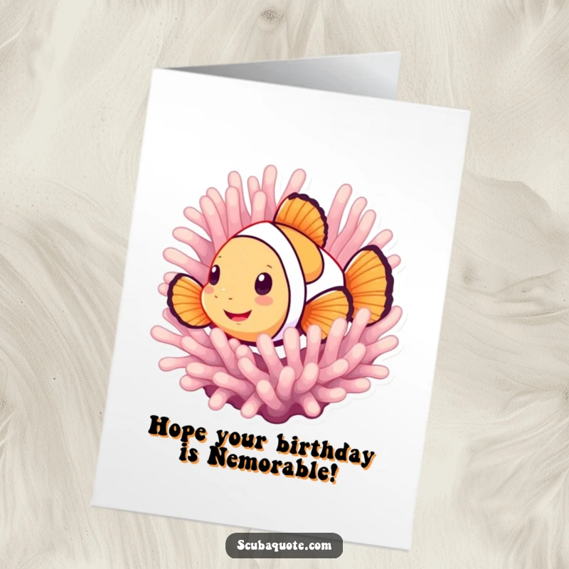 Funny Free Printable Birthday Card showing a smiling clownfish playfully peeking from behind a vibrant anemone, ready to celebrate.
